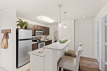 A kitchen with granite countertops and stainless steel appliances